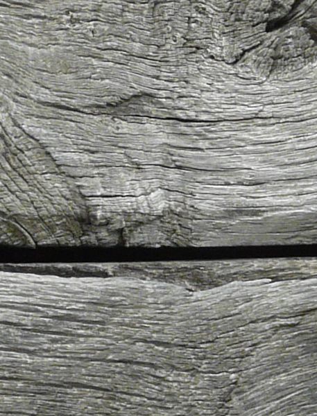 Grey planks with varying surfaces placed horizontally.